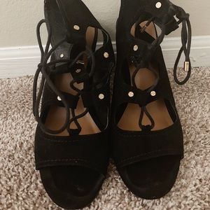 Strappy, black heeled, sandals.